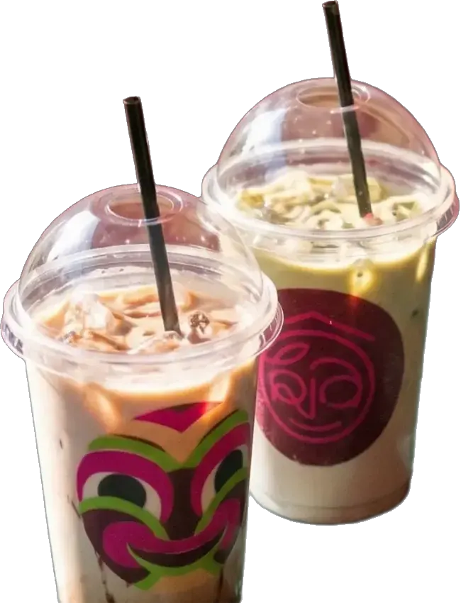 Two iced drinks in ÔKia cups, one printed with a mask, one with the ÔKia logo sticker